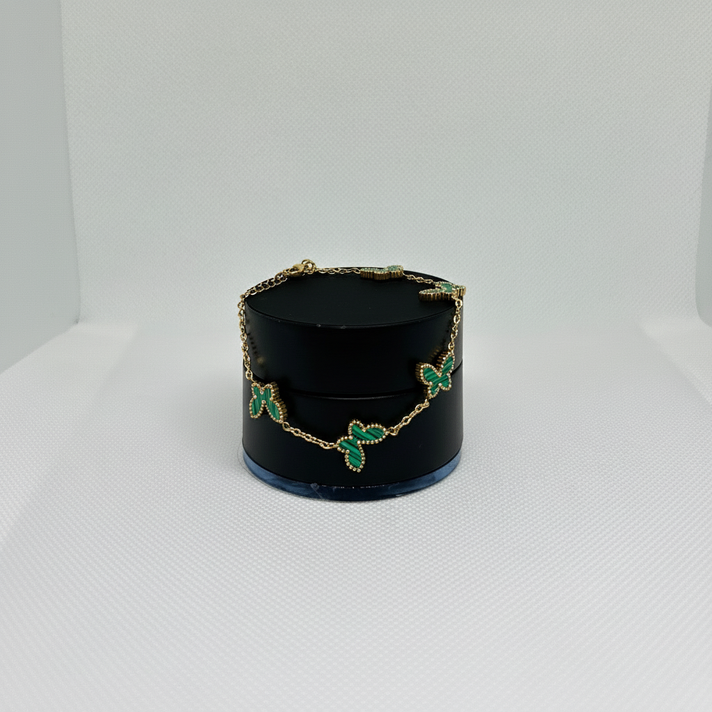 Gold bracelet with green gemstones 